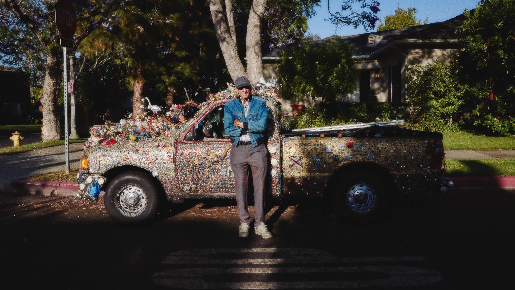 Person standing next to a decorated truck in a residential area