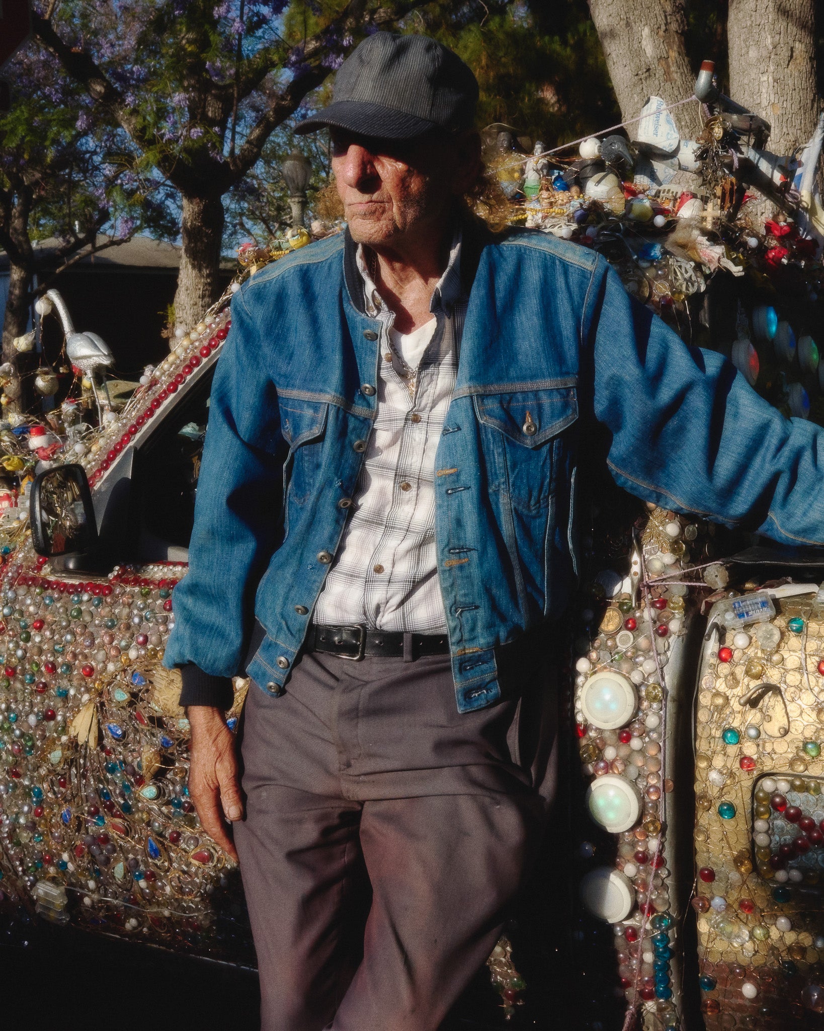 Man standing next to a colorful, embellished vehicle